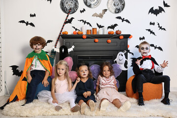 Sticker - Funny children wearing costumes for Halloween celebration in decorated room