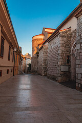 Krk Croatia 28.06.24A quiet street at dawn near an old church