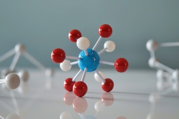 Colorful molecular model is standing on a white surface with other models out of focus in the background