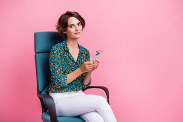 Poster - Photo of young influencer girl in smart casual outfit sitting boss chair browsing news x social media isolated on pink color background