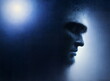 © Louve - Artistic portrait of a male face, contemplative mood, dark blue abstract background