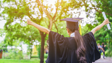 Graduate woman students wearing graduation hat and gown, congratulations for end of study