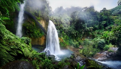 A powerful waterfall cascading down a rocky cliff, surrounded by lush tropical foliage. Mist rises from the water, creating a sense of freshness and movement in the dense jungle.