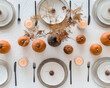 © LouD - Minimalist fall-themed table setting with pumpkins