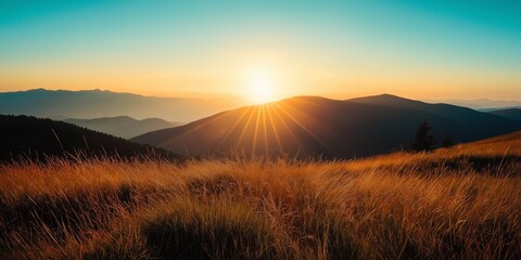 Golden sunrise casting light over grassy mountain terrain with radiant sunbeams piercing the sky. Inspiring natural beauty.