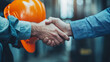 © Tanuha - Architect and engineer construction workers shaking hands while working for teamwork and cooperation concept after finish an agreement.