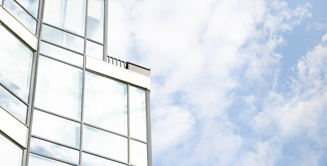 modern glass facade office skyscraper building high close up elements corner and window shape with cloudy blue sky background panorama format of picture