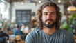© Sandu - Young man with long hair and beard sitting in a café