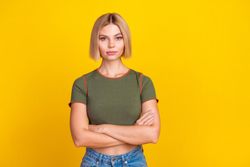 Sticker - Photo of serious gorgeous confident girl with bob hair dressed khaki t-shirt holding arms folded isolated on yellow color background