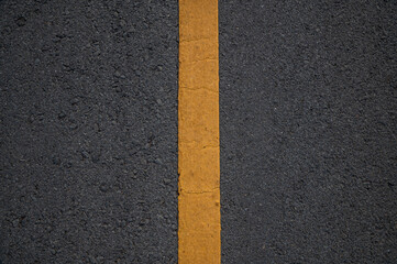 Asphalt road with yellow line in the middle.
