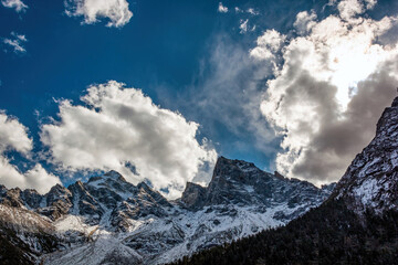 Scenery of plateau snow mountains under blue sky and white clouds