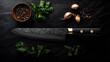 © Kingdola - Damascus steel knife laying on a modern black countertop