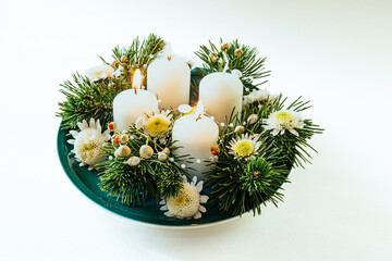 advent wreath with four white candles, 3 candles burning