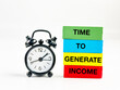 © Ardini - alarm clock and colorful block with text of time to generate income. finance and time management concept.
