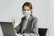 © Hype2Art - Professional woman using laptop working office face mask safety business corporate attire workspace