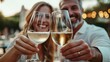 © The Little Hut - Vertical Mature smiling couple toasting white wine glasses to the camera Middle aged married people drinking alcohol on a bar terrace Two adult partners clinking with alcohol beverages : Generative AI