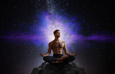 Wall Mural - Man in yoga pose meditation in the nature cosmos