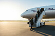 © TAMER YILMAZ - Passengers boarding the aircraft from the stairs of a passenger aircraft at the airport.