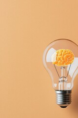 Wall Mural - Unique light bulb design featuring a brain shape inside on a soft peach background