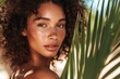 © Pixcellence - Beautiful Woman with Curly Hair and Tropical Leaves