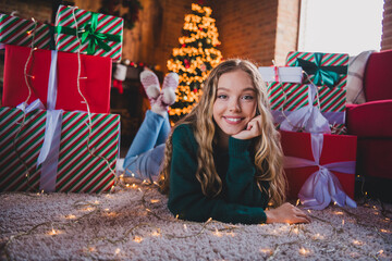 Poster - Full body photo of nice teen girl lying floor gifts dreamy wear green christmas clothes cozy x-mas party decoration interior flat indoors