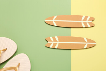 Wall Mural - Mini surfboards and flip-flops on color background