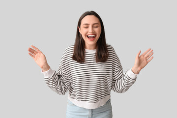 Sticker - Smiling young woman on grey background