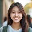 © Ace64 Studio - Headshot of young happy attractive asian student smiling and looking at camera with friends on outdoor university background. asian woman in self future education or personalized learning concept.
