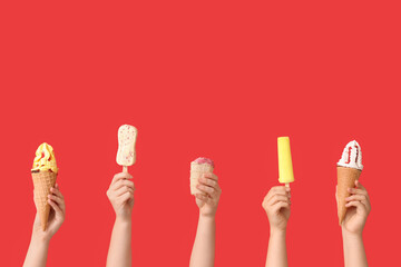 Wall Mural - Female hands with different sweet ice-cream on red background