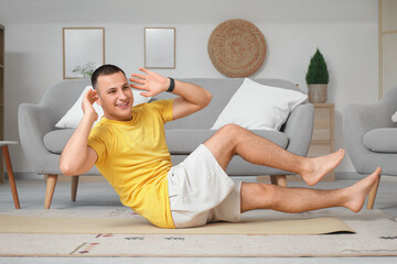 Canvas Print - Sporty young man training at home