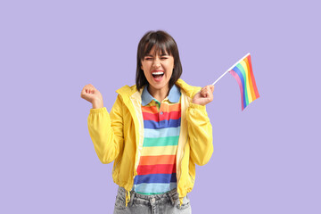 Canvas Print - Happy young woman in rainbow t-shirt with LGBT flag on lilac background