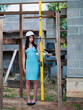© mark_gusev - Teenager girl in high fashion blue dress and white hard hat posing on a construction site of a new house. Model has slim body type. Looking after home building concept. Glamour in unusual location