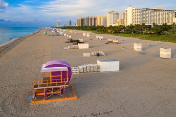 Sandy beachfront with lifeguard hut, art deco hotels and condos. Miami Beach, Miami, Florida, United States.