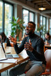 © Derek Brumby - A young professional in casual attire enthusiastically gestures while engaging in an animated discussion near a laptop in a bustling café environment.