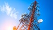 © Elmira - The tall telecommunication tower rises prominently under a clear blue sky, equipped with multiple antennas and satellite dishes that facilitate digital connectivity across networks