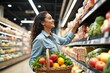 © Derek Brumby - A joyful woman with long hair in a denim shirt is selecting groceries from a colorful and well-stocked aisle, demonstrating the abundance of choices in modern supermarkets.