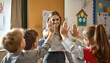 © Gayan - A beautiful elementary school teacher warmly welcomes her students at the door with a high-five, creating a positive and cheerful atmosphere as they enter the classroom for the day