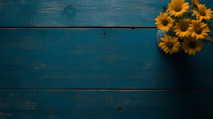 Poster - A small vase holds bright yellow daisies, adding a cheerful touch to a rustic blue wooden table. The vibrant petals contrast beautifully with the faded paint background, ideal for text