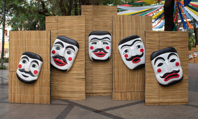 colorful masks on a wooden wall