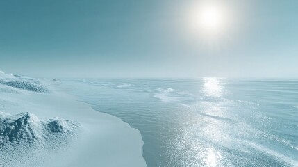 Wall Mural - A scenic view of a bright, sunny day with a clear blue sky and a calm ocean meeting a snow-covered shore.