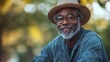 © Five Million Stock - Happy mature senior black african american man riding his bicycle through a park on a sunny day,