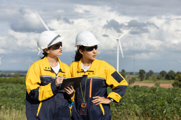 Fototapete - Female engineer wind turbine worker survey operational planning windmill clean renewable energy technology for future. Alternative technology protect environment reduce global warming problems.
