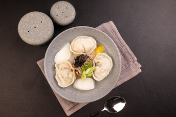 Wall Mural - Tteok Mandu Guk is Korean Dumpling and Rice Cake Soup for New Year Celebration.