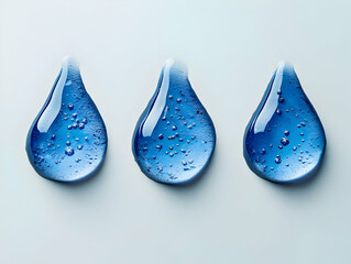 Poster - Three water droplets with a blue tint on a white isolated background.