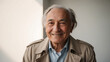 © Olena Yefremkina - An elderly man in a raincoat is smiling.