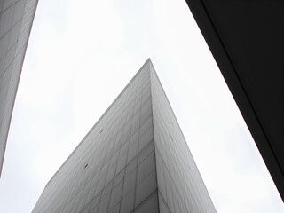 Abstract architecture of a modern office building with a cloudy sky in the background