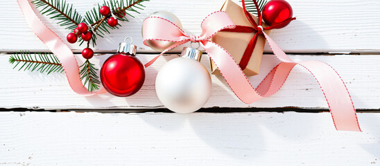 Poster - Christmas Ornaments and Gift Box on White Wooden Background