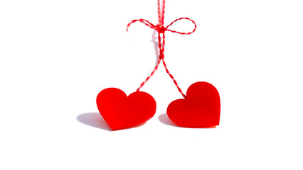 Sticker - Two red hearts hanging on a red string, isolated on white background