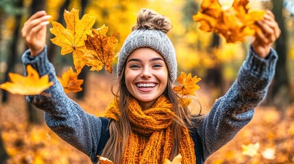 Wall Mural - Beautiful young woman throwing autumn leaves in the air and smiling