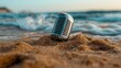 © thanarak - Close up of a vintage retro style microphone half buried in the sand at the edge of a tranquil beach with waves gently approaching the shoreline in the background